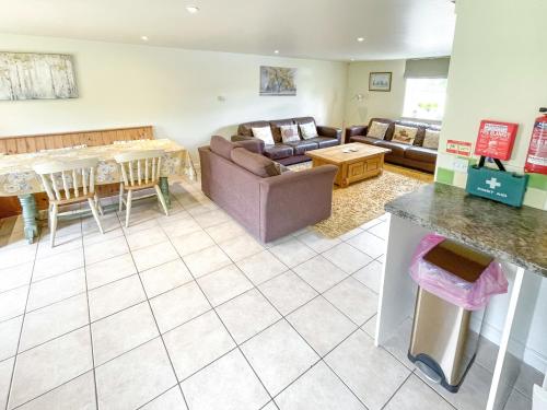 a living room with a couch and a table at Lily Pad 2 - Uk43901 in Nassington