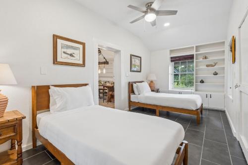 a bedroom with two beds and a chair and a table at 3BR Cabin Sleeps 10 Fenced Yard in Oklahoma City