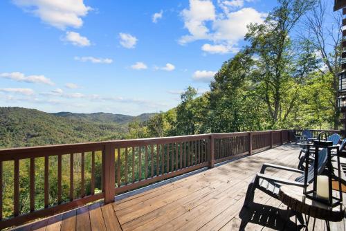 a deck with benches and a view of the mountains at Cranberry View Lodge in Newland