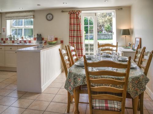 a kitchen and dining room with a table and chairs at Lily Pad 1 - Uk49648 in Nassington