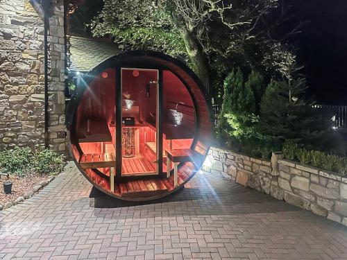 a circular object is sitting on a brick sidewalk at Tennox Parlour - Ukc3542 in Kilbirnie