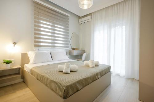 a bedroom with a bed with two towels on it at Elia Apartments in Ierissos