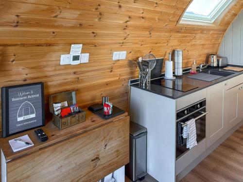 a kitchen with wooden walls and a counter top at The Rounton - Ukc9284 in Brompton