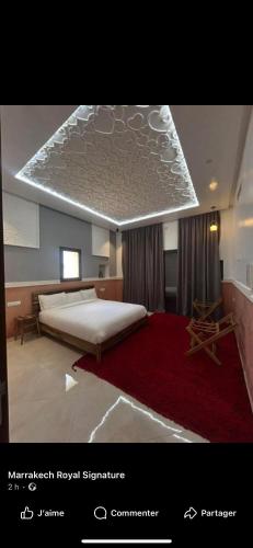 a bedroom with a large bed and a red rug at Mandarine de medeline in Ouled el guerne