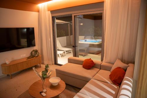 a living room with a couch and a large window at CASA Terraya in Afantou