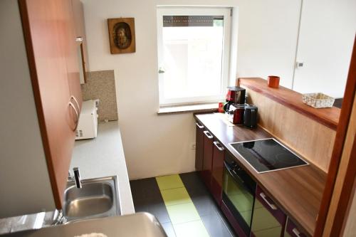 a small kitchen with a sink and a window at Počitniška hiša REMA in Lendava