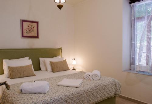 a bedroom with a bed with two towels on it at Feneri- cozy Apartment 20' from Elafonisi beach in Elafonisi