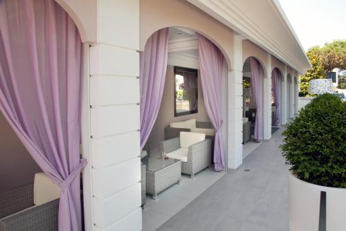 a corridor of a building with purple curtains at Hotel Villa Paola in Rimini