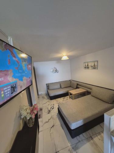 a living room with a couch and a flat screen tv at Ionian Balcony II in Athani
