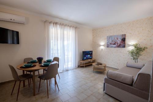 a living room with a couch and a table at Corfu Glyfada Beach Apartment in Glyfada