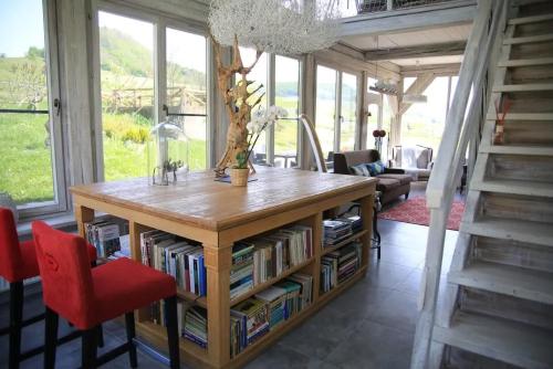 a living room with a table with books at Cross Country Farm in Prod