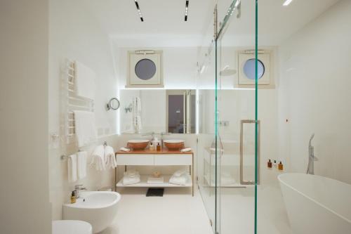 a white bathroom with a shower and a sink at Palazzo M Capri in Capri