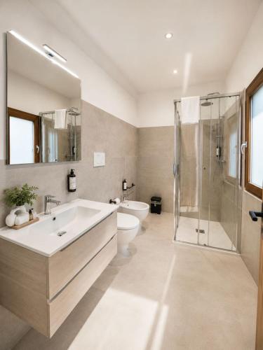 a bathroom with a sink and a toilet and a shower at Suite San Biagio in Lecce