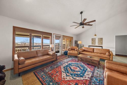 a living room with two couches and a rug at Oma's Beech House in Beech Mountain