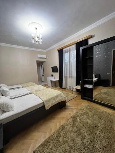 a bedroom with a large bed and a large window at Hotel Villa DavidL in Sagarejo