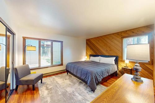 a bedroom with a bed and a desk and a chair at Snowcreek 27 in Mammoth Lakes