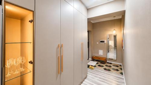 a hallway with a glass door leading to a bathroom at Stylish Cozy Apartment in UB in Ulaanbaatar