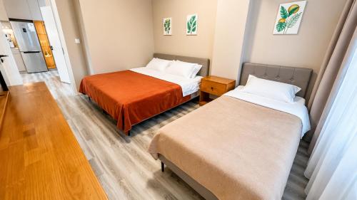 a room with two beds in a room at Stylish Cozy Apartment in UB in Ulaanbaatar