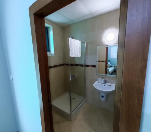 a bathroom with a shower and a sink at Sunny Cozy Apartment Primorsko in Primorsko