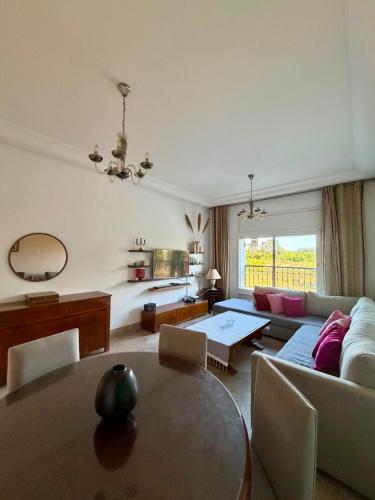 a living room with a couch and a table at Comfy 2Bdrs Marsa in Carthage