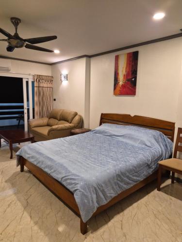 a bedroom with a bed and a couch at New world condo1104 in Ban Chak Phai