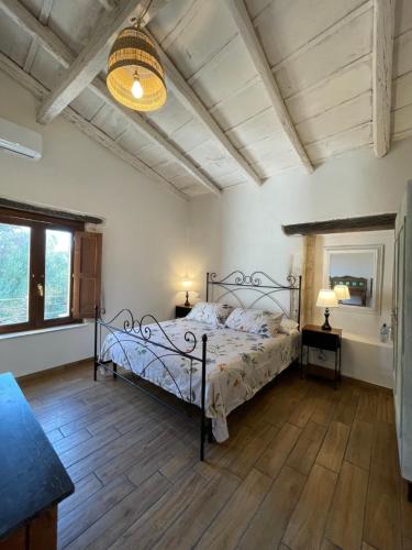 a bedroom with a bed with a wrought iron frame at Mater Familias Oasis in Syracuse