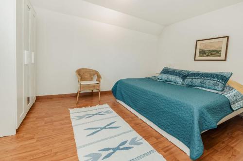 a bedroom with a bed and a chair and a rug at Haus Teltow in Teltow