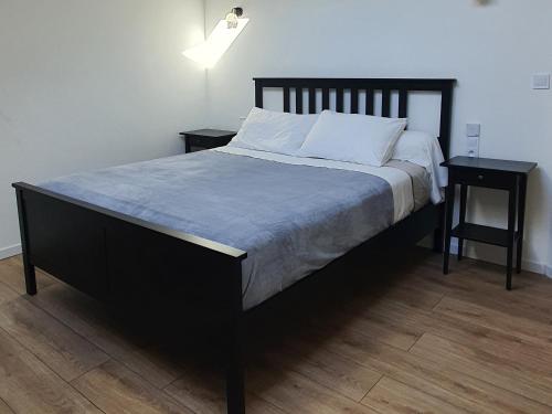 a bedroom with a large bed with two night stands at La Grange Des Roches Roses in Anchenoncourt-et-Chazel