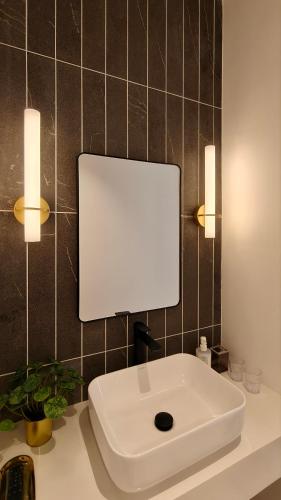 a white sink on a counter in a bathroom at Milano8 Condominium Opposite Vivacity in Kuching