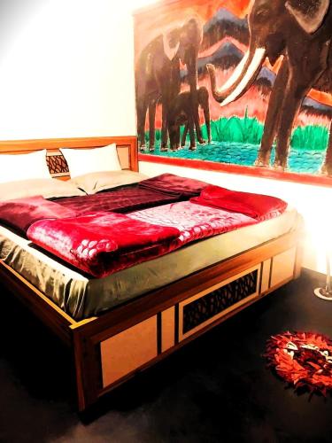 a bed in a room with a painting on the wall at Green Mountain Cabin in Nuwara Eliya