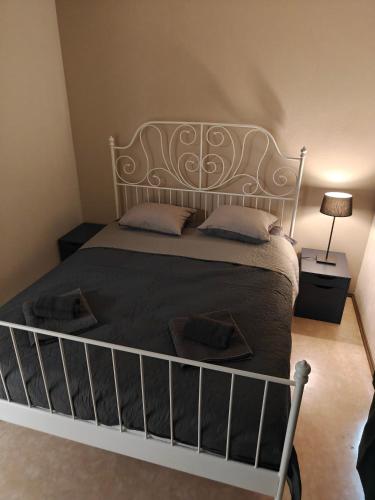 a bedroom with a bed with a wrought iron headboard at Majoitus Kulma 2 in Ilomantsi