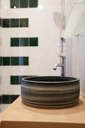 a stack of plates sitting on a counter next to a sink at Gut Boltenhof in Fürstenberg