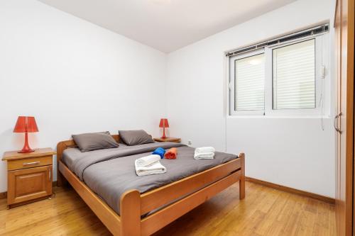 a bedroom with a bed with towels and a window at Kotor Muo F1 in Muo