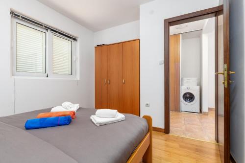 a bedroom with a bed with towels on it at Kotor Muo F1 in Muo