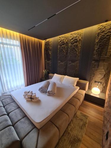 a large bed in a room with a large couch at MOCCA Lux Suite in Bitola