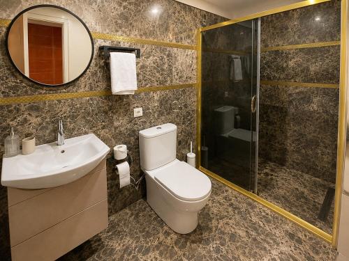 a bathroom with a toilet and a sink and a shower at Reco Luxury Suite in Kavaklıdere