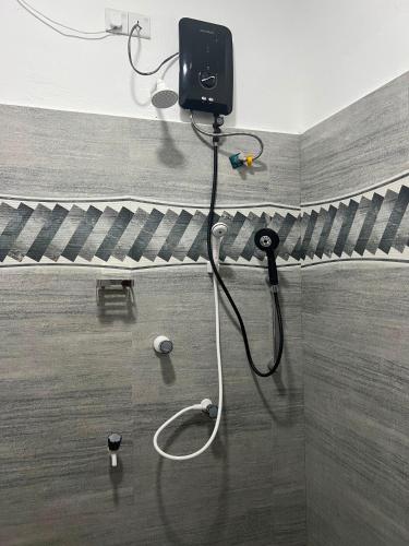 a bathroom with a hose attached to a wall at Grand Bay Hotel in Arugam Bay