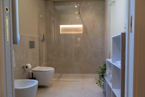 a bathroom with a shower and a toilet and a sink at Villa Angheli in Giardini Naxos