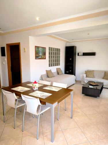 a living room with a table and a couch at Central Moudros apartments in Moúdhros