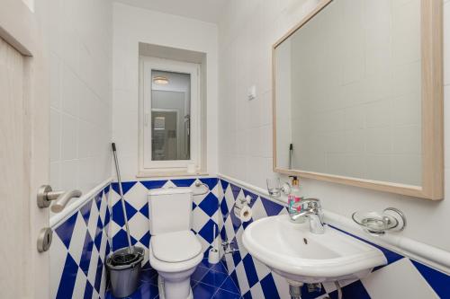 a bathroom with a white toilet and a sink at Lavender house with shared pool in Herceg-Novi