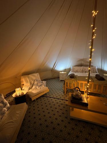 a room with two beds in a tent at Hedgerow hideaway in Llanvetherine