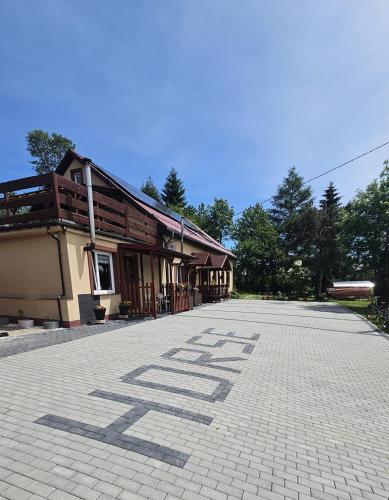 a building with the word help written on the ground at Czarny Koń i Biały Koń Black Horse & White Horse Apartamenty in Kamienna Góra