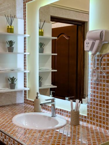 ein Badezimmer mit Waschbecken und Spiegel in der Unterkunft Etno Sobe in Smederevo
