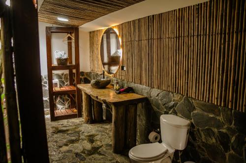a bathroom with a sink and a toilet and a mirror at Glamping Salento in Salento