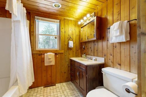 a bathroom with a toilet and a sink at Twin View Log Home in Carroll