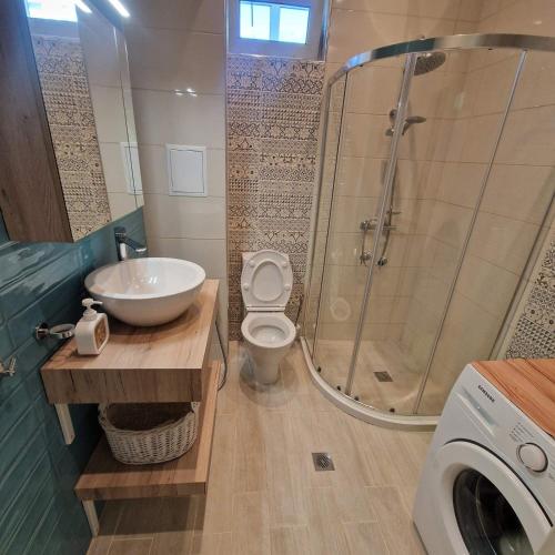a bathroom with a sink and a toilet and a shower at Blue Dreams - City Center Burgas in Burgas