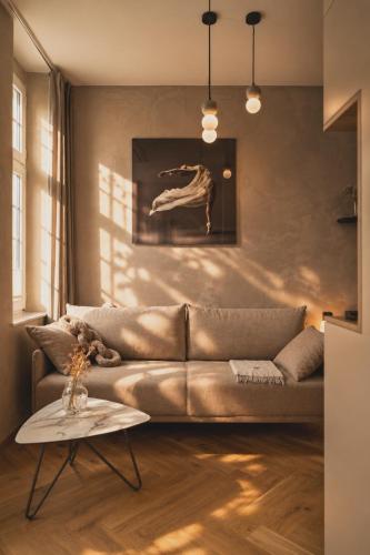 a living room with a couch and a table at Stylish City Center Escape- Where Modern Elegance Meets History in Trier