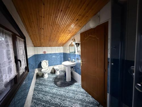 a bathroom with two toilets and a sink at Hotel Laura in Velipojë