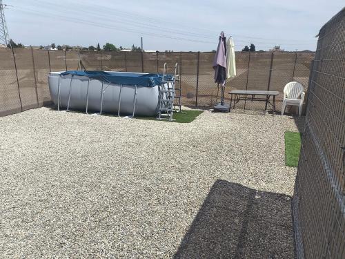 a patio with a trampoline and a table and a fence at Casa Campo Gerena in Sanlúcar de Barrameda
