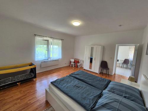 a bedroom with a bed and a table and chairs at Barlang utca Villa in Cserszegtomaj